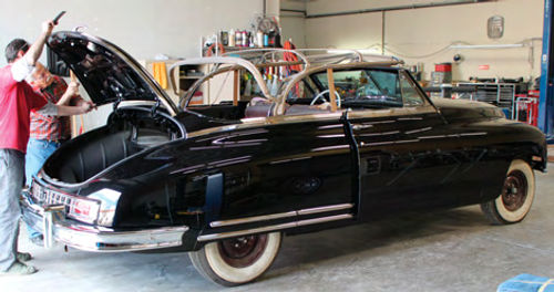 Photo 6. Installing the chrome strip on the Packard’s trunk lid.