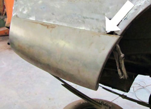 Photo 3. The lower rear section is clamped into place so that the original quarter panel can be marked for cutting.