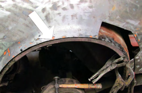 Photo 8. This is where I used one of the fabricated arch pieces to form a new wheel house panel welding flange.