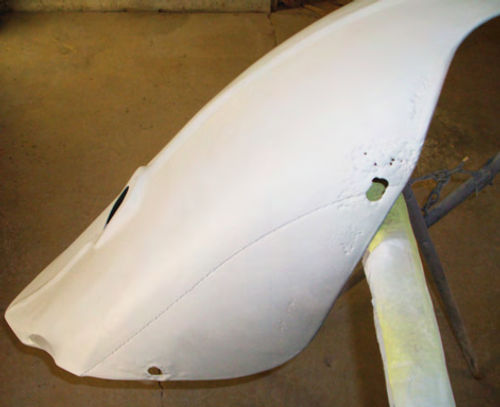 Many original panels, like this left rear fender, had small spots of rust, minor dents, stress cracks or shallow indentations.