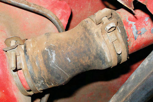 Photo 7. A loose clamp (left) allowed dirt to enter where the filler-neck flex hose met the gas tank.