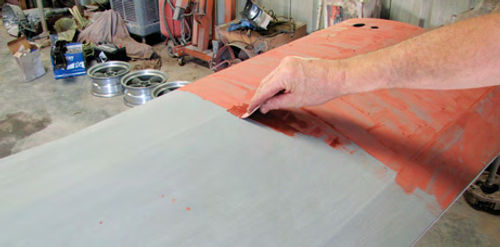 Photo 4. Some 3M Super Red Putty is applied using a small plastic applicator. Notice that the coat doesn’t have to be heavy. It just needs to cover the entire panel.