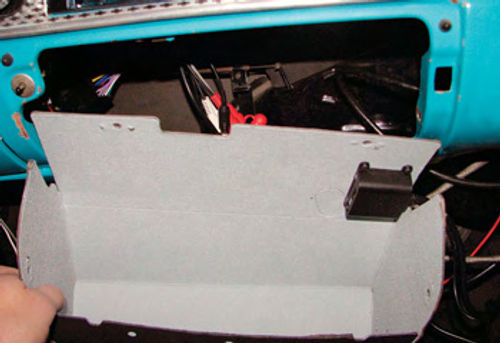 Photo 12. The auxiliary interface unit was attached to the top of a new glove box liner. The interface allows for loading digital music using a USB flash drive, an SD flash card, or a place to plug in an iPod or MP3 player.