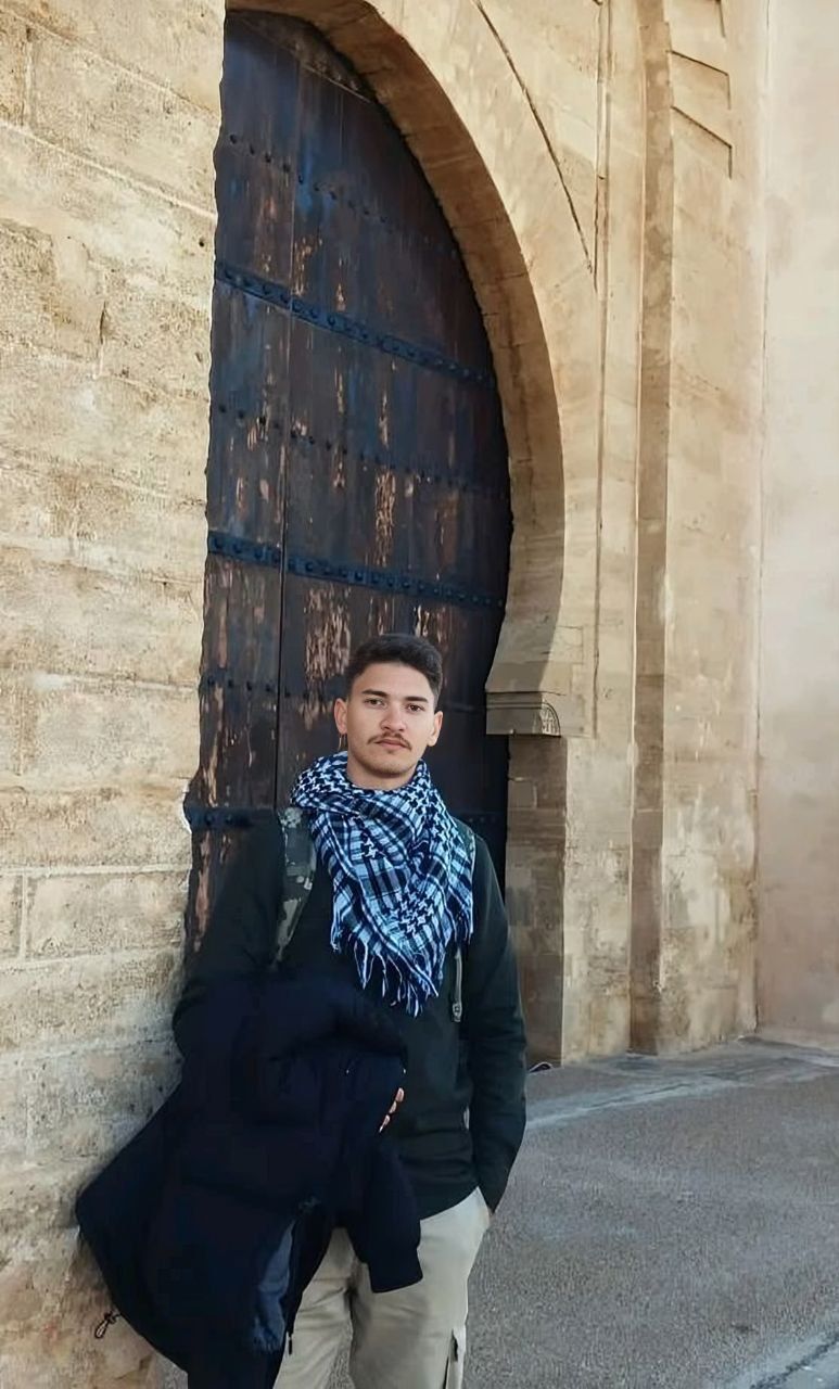 Monsif in his studio with artwork