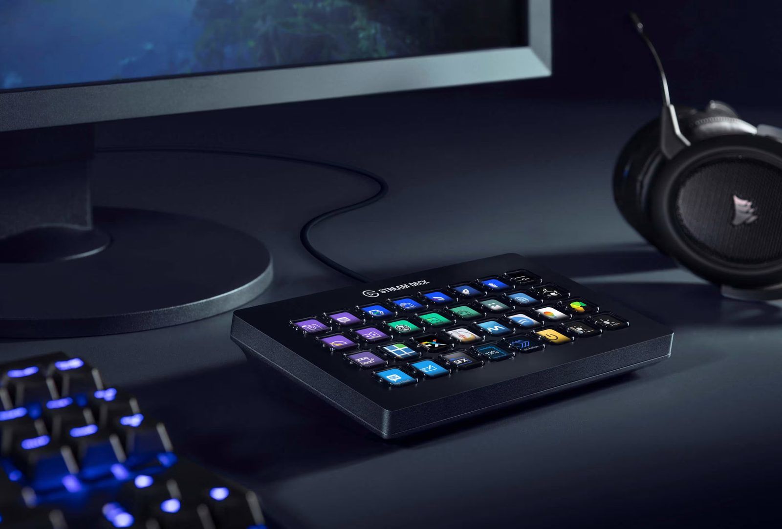 Stream Deck XL sitting on a desk beside a keyboard, its 32 backlit LCD keys each showing a different coloured icon