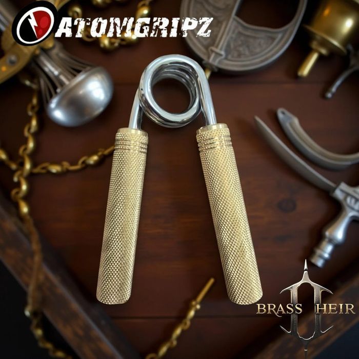 Atomgripz Brass Heir gripper with solid brass knurled handles resting on dark wood