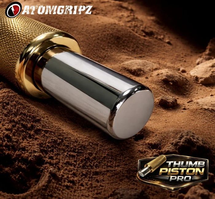 Atomgripz Thumb Piston Pro, a knurled chrome and gold cylinder for isolated thumb training