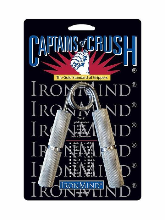 IronMind Captains of Crush gripper in its blue and yellow blister pack, knurled aluminium handles and a coiled steel spring