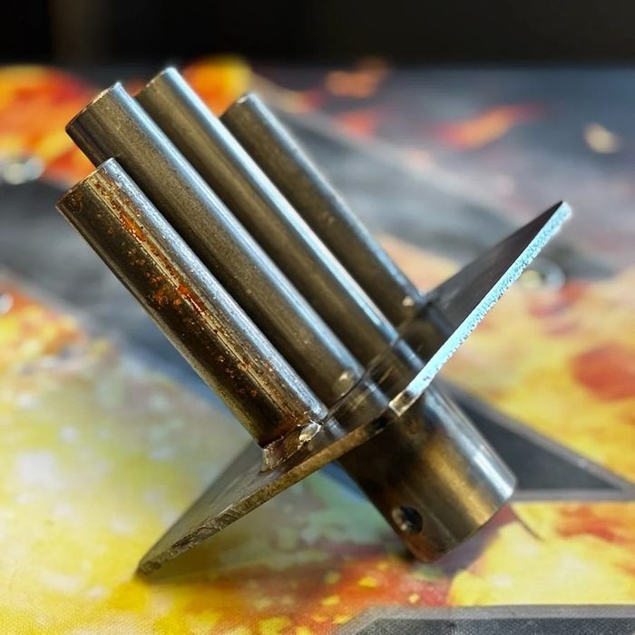 Raw steel GripTopz interchangeable lifting tops, cylinders and a blade shape welded to a base plate