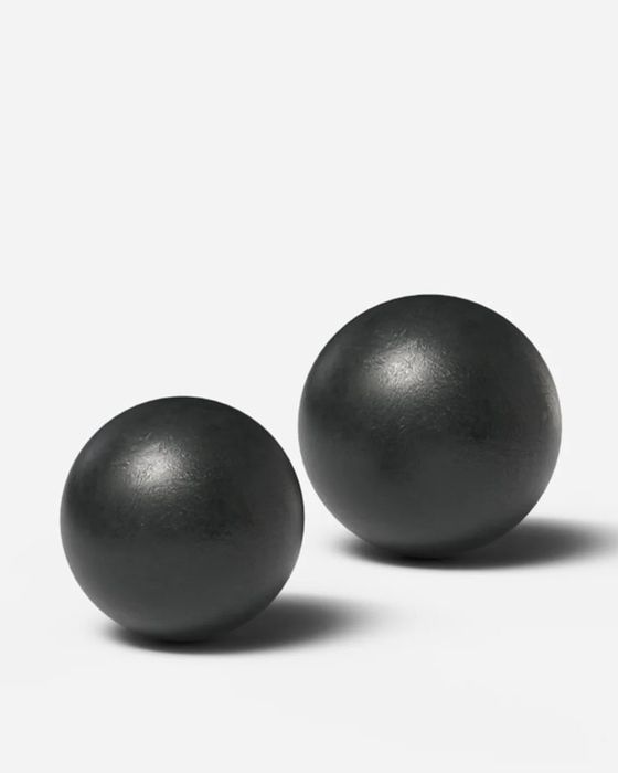 Two Gods of Grip cannonball blobs, plain black steel spheres for open-hand lifting