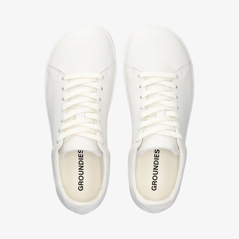 Top-down view of a pair of white Groundies Zero showing the wide anatomical toe box and narrow waist
