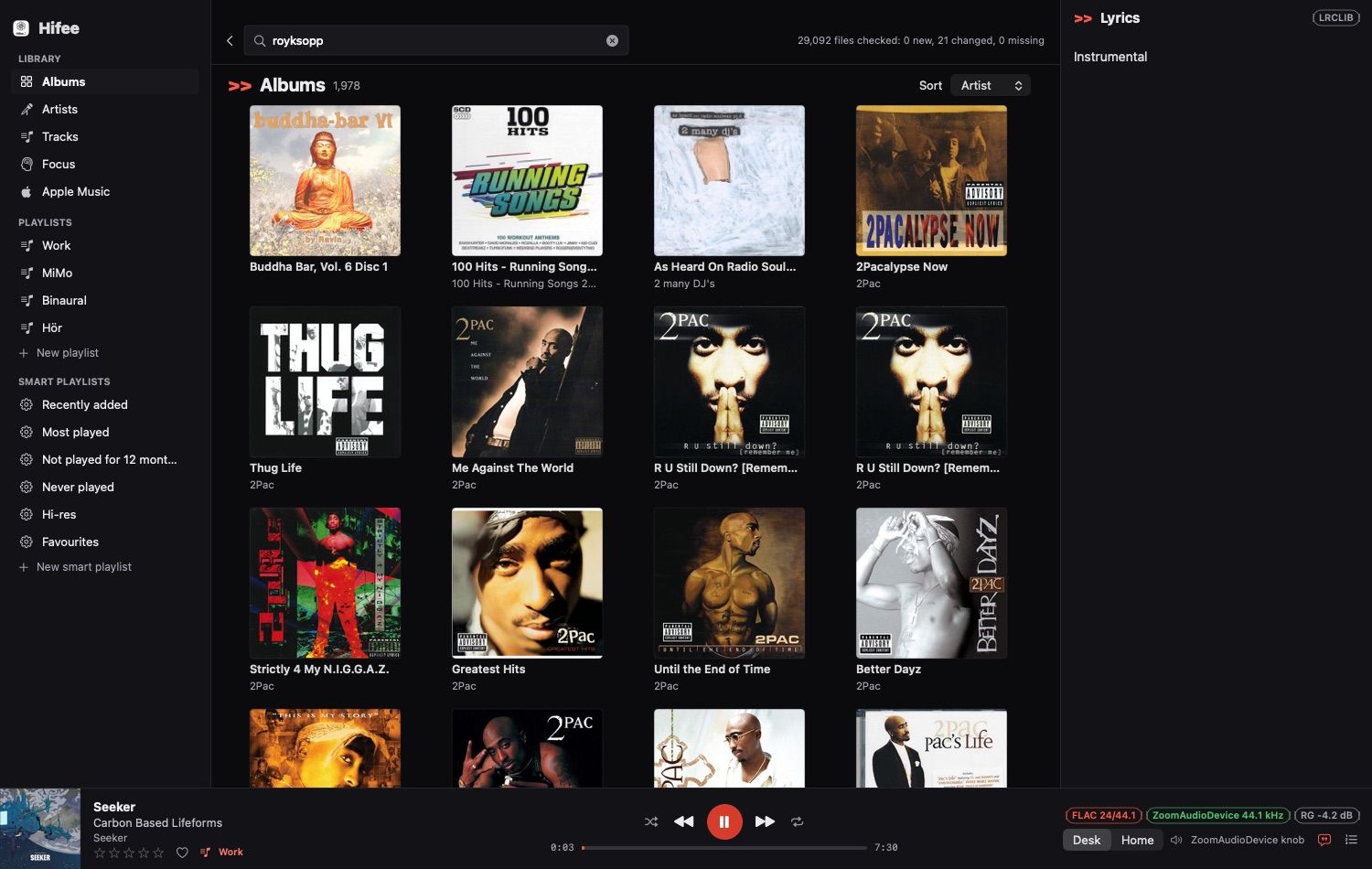 Hifee's main window in dark mode: a sidebar with library sections and playlists, an album grid, a lyrics panel on the right, and a player bar with the cover in the bottom-left corner