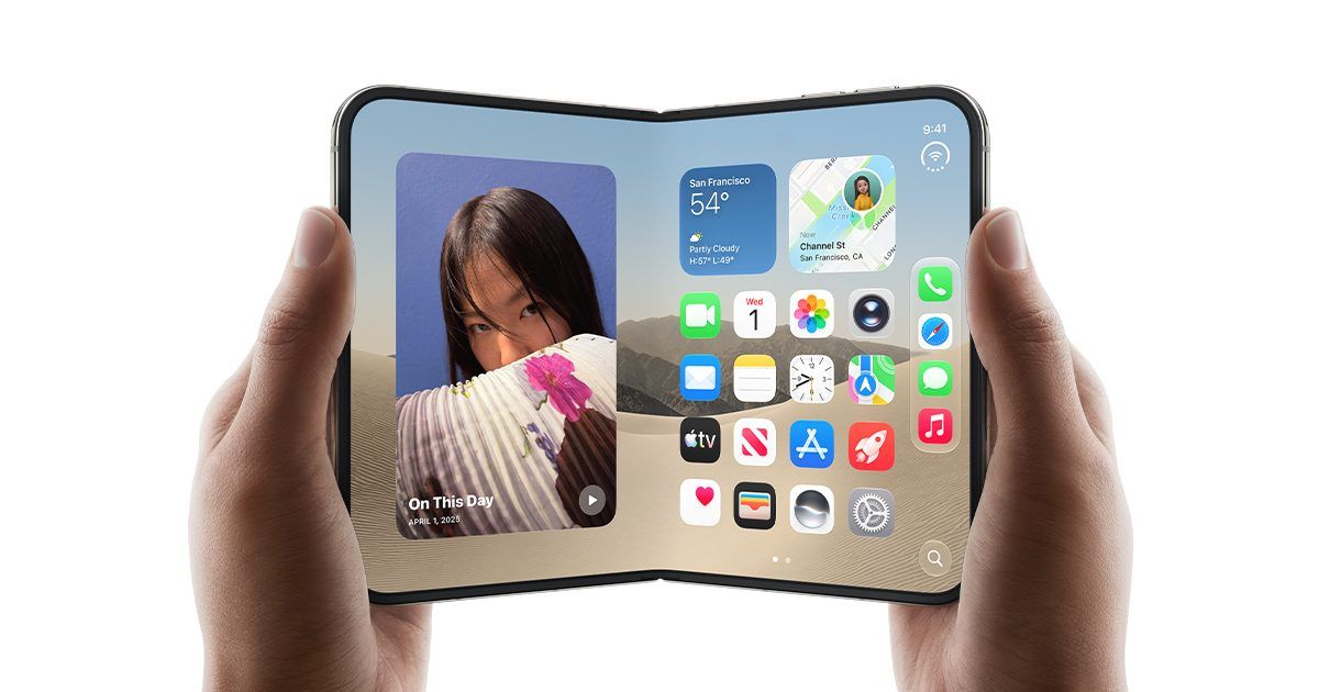iPhone Duo held open in two hands showing the home screen across the full inner display, with the fold line visible down the centre