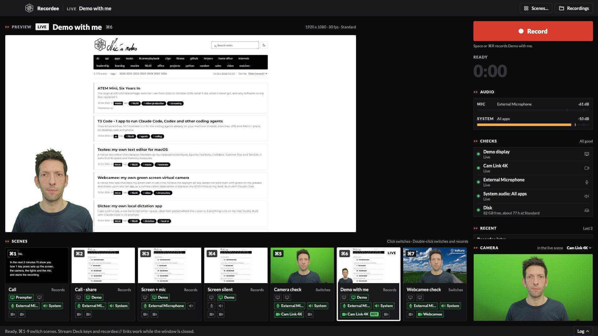 The Recordee window in dark mode: the live preview of the Demo with me scene, a web page with me keyed in the bottom-left corner, the red Record button, audio meters, source checks, and 7 scene tiles with a large shortcut badge and green Display, Audio and Camera rows