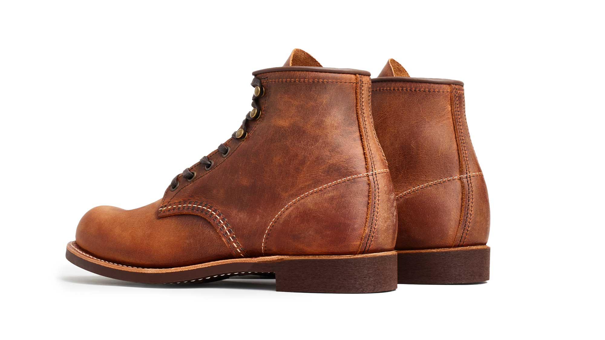 Rear three-quarter view of the Blacksmith 3343 pair: the stitched heel counter, the pull-up leather lighter on the heel where it flexes, and the stacked dark heel of the sole