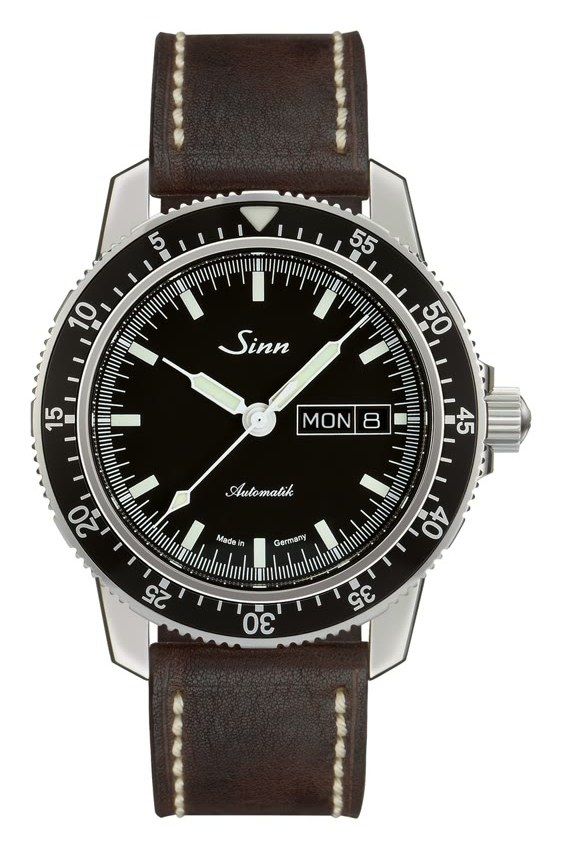 Sinn 104 St Sa I on a brown leather strap with cream stitching: black dial with luminous baton markers, day-date window at 3 o'clock and a black rotating bezel with a 60-minute scale
