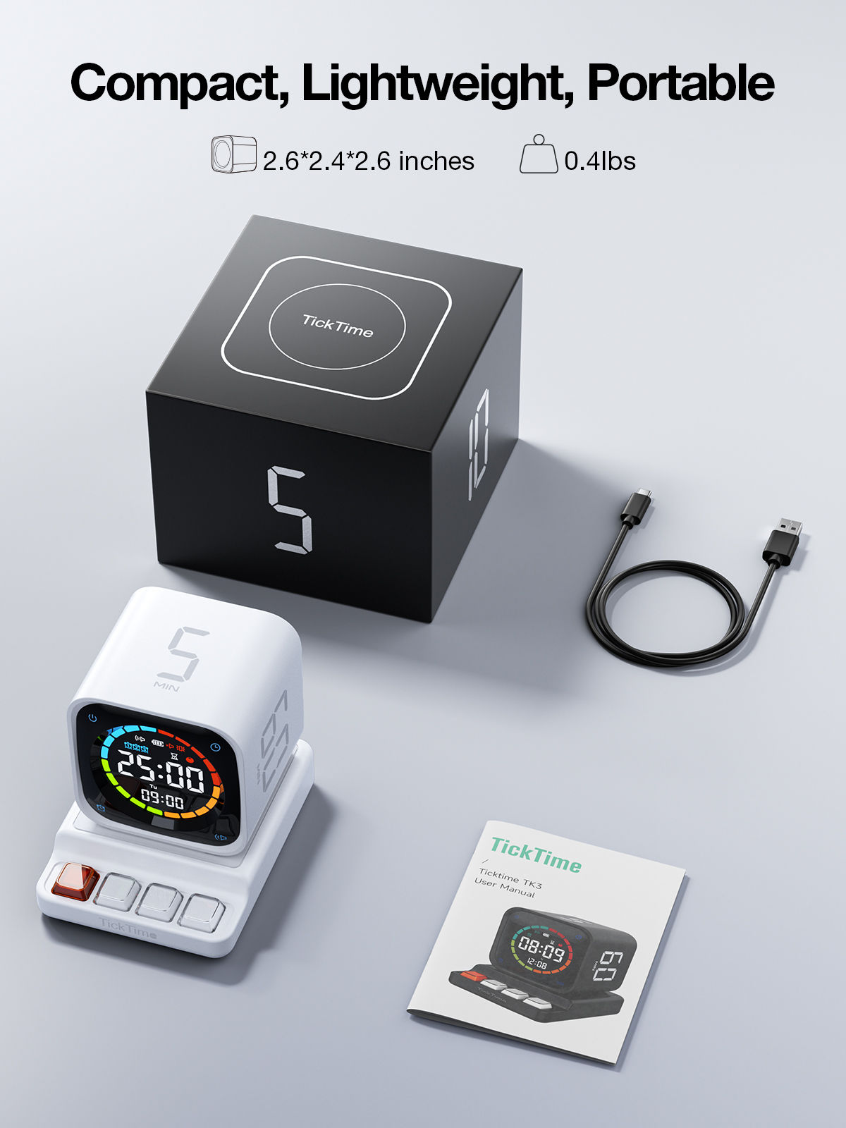 TK3 unboxing layout: the white cube on its four-button base, a black cube-shaped retail box, a USB-A to USB-C cable and a folded user manual
