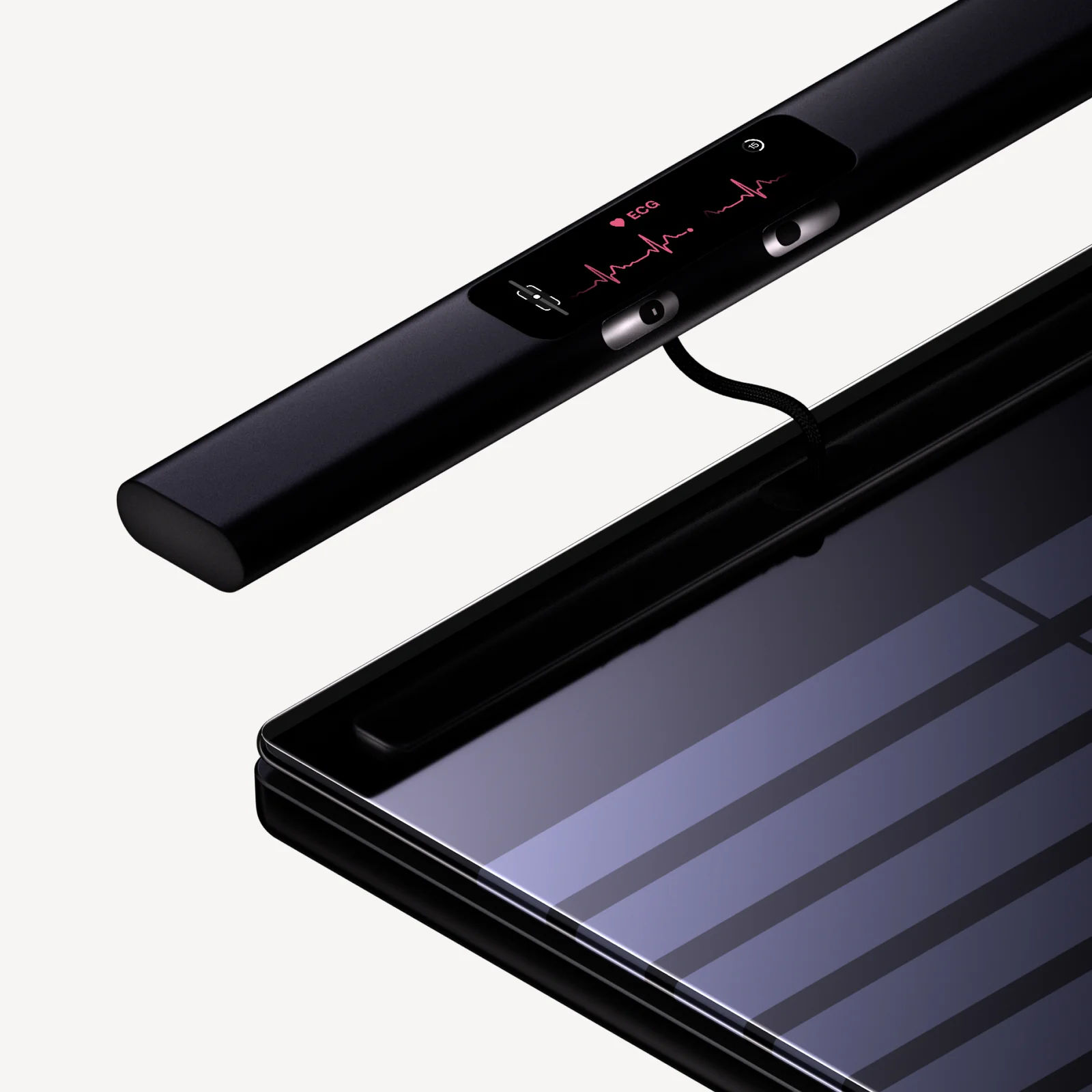 Close-up of the Body Scan 2 handle showing an ECG trace on its colour display alongside two of the four steel grip electrodes