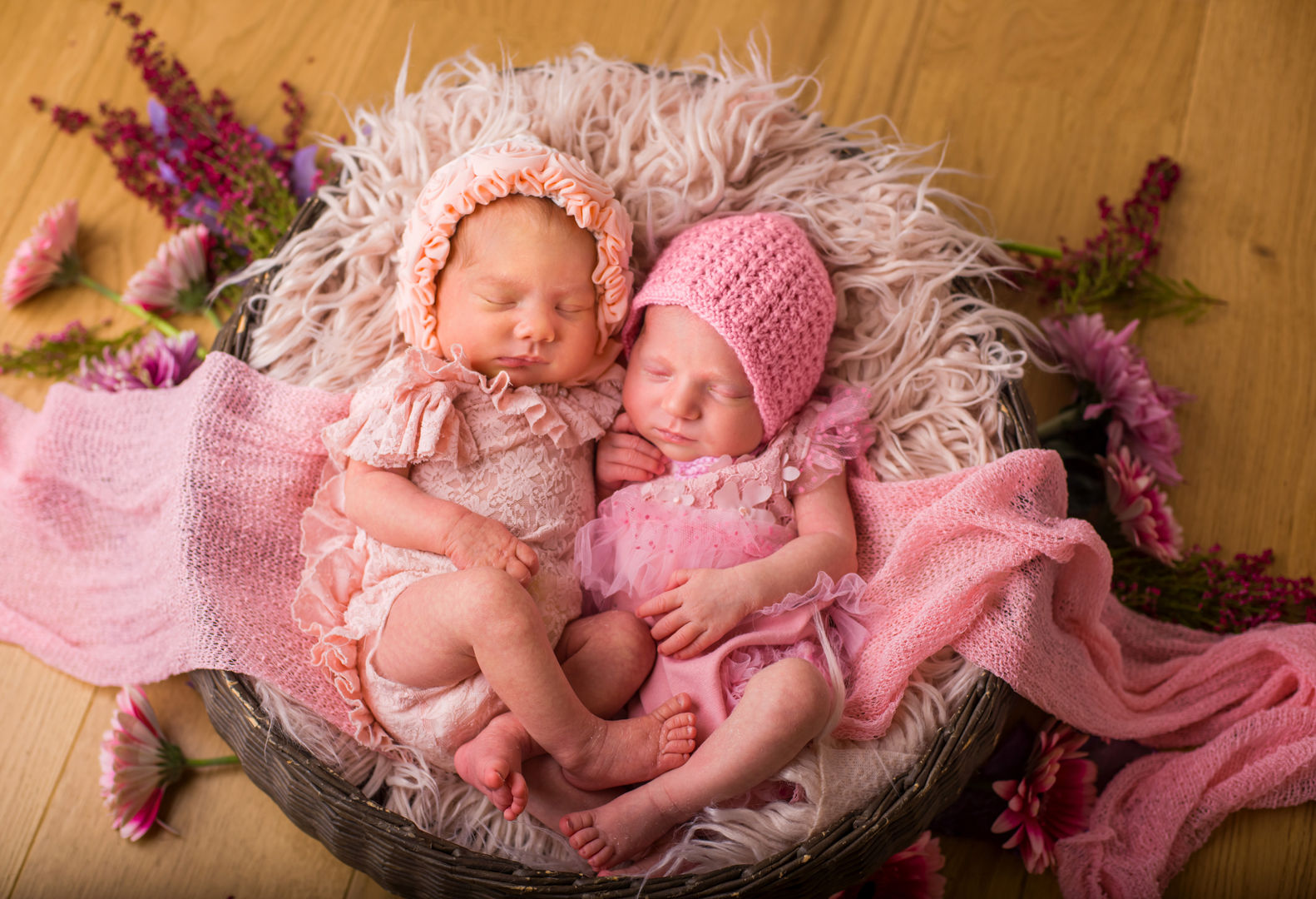 Twin newborns in pink bonnets - artistic twin baby photography Los Angeles