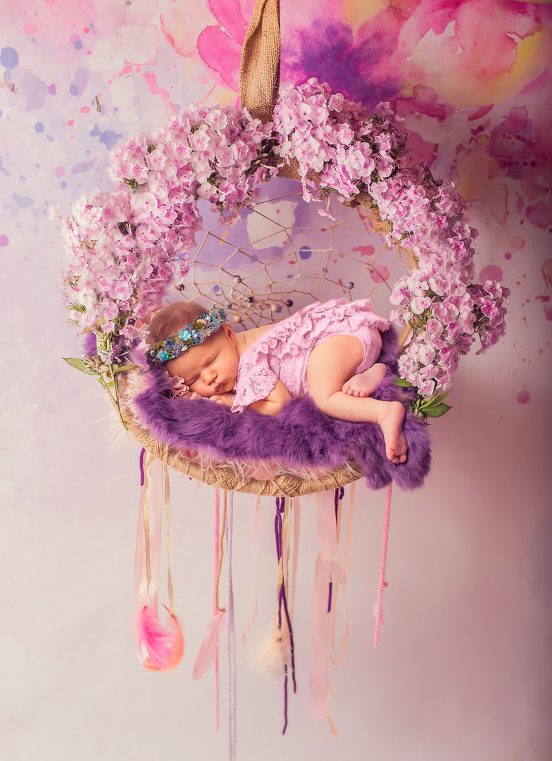 Newborn in hanging dreamcatcher with flowers - fine art baby portrait