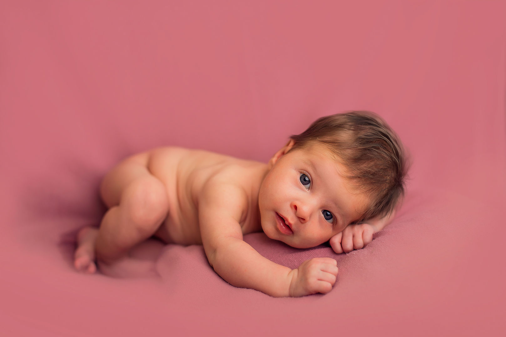 Newborn in basket with flowers - artistic baby portrait