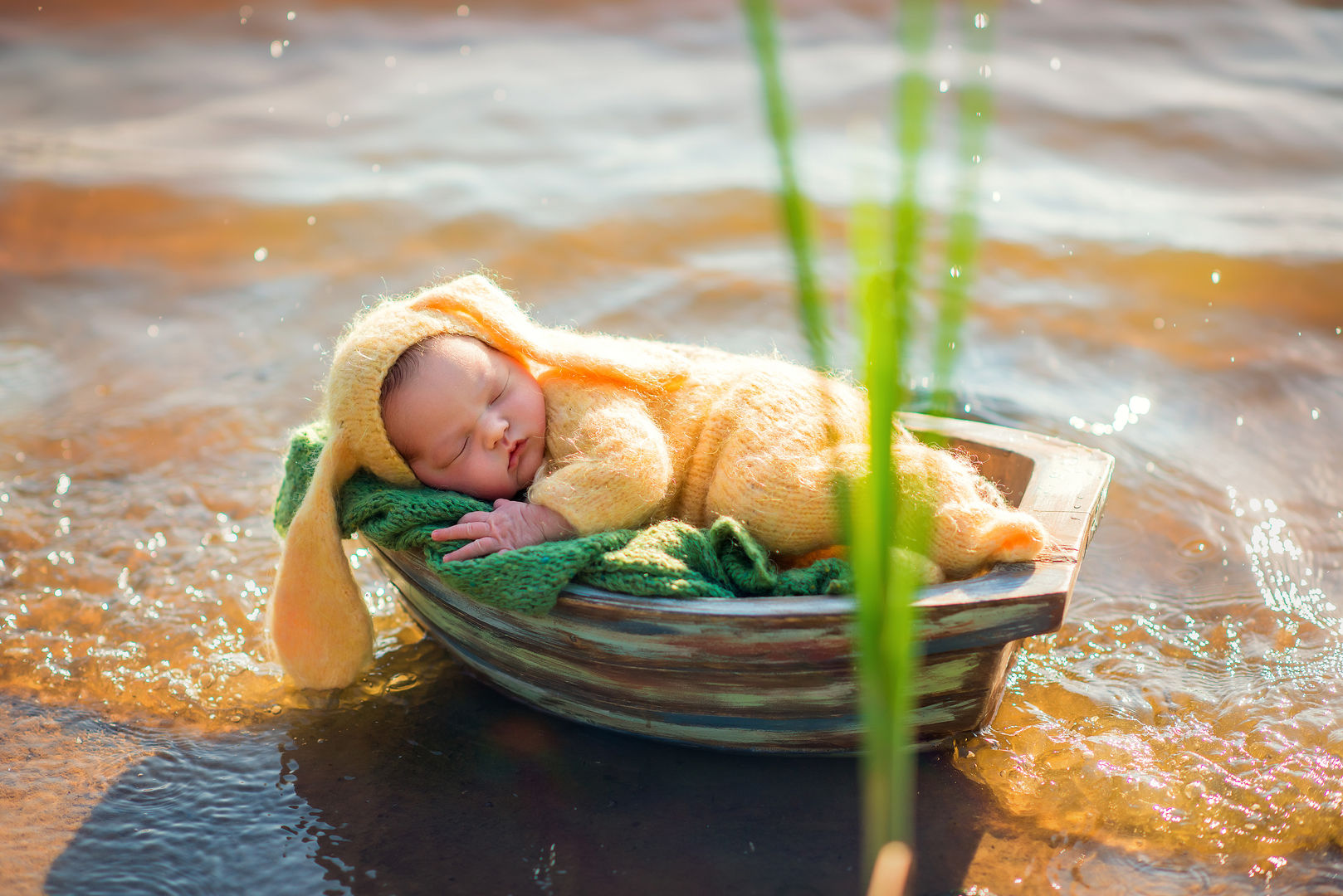 Newborn in yellow outfit in boat - outdoor baby photography Los Angeles