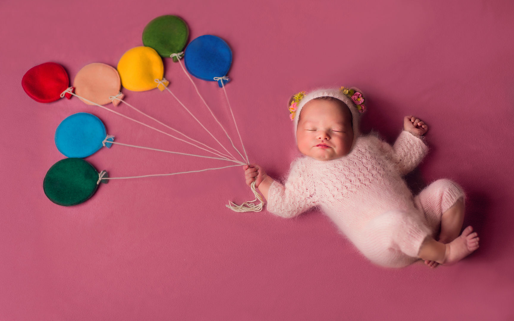 Newborn in basket with flowers - artistic baby portrait