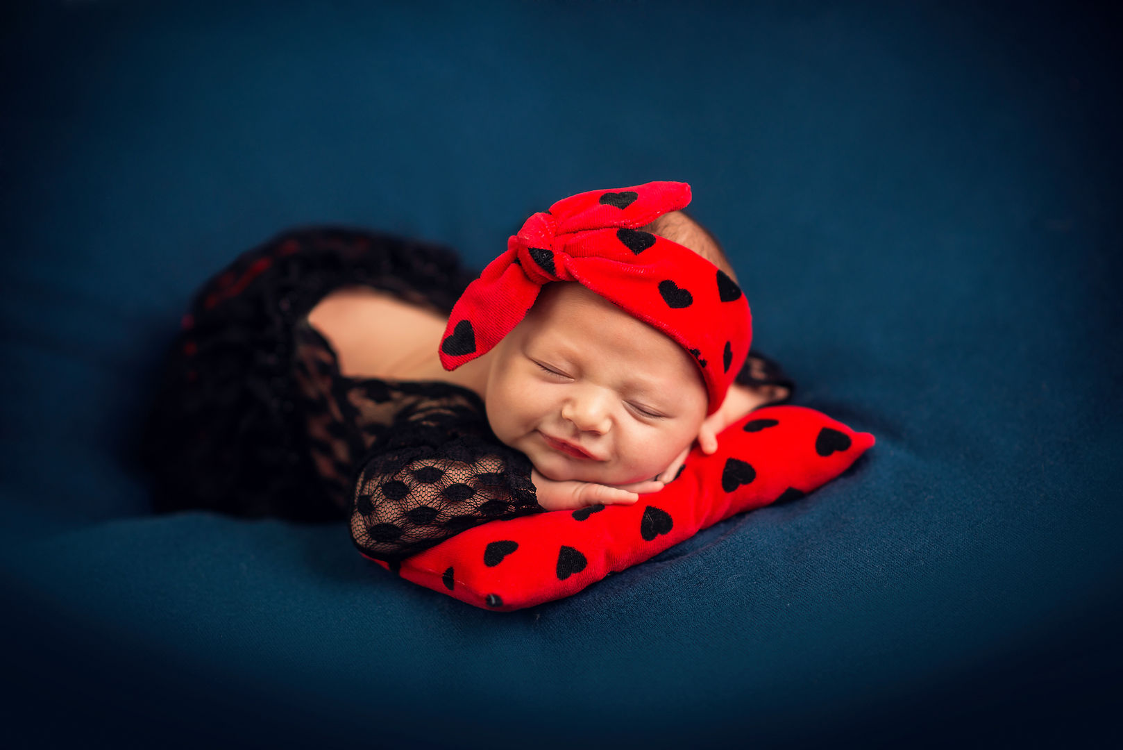 Peaceful newborn sleeping in basket - artistic baby photography