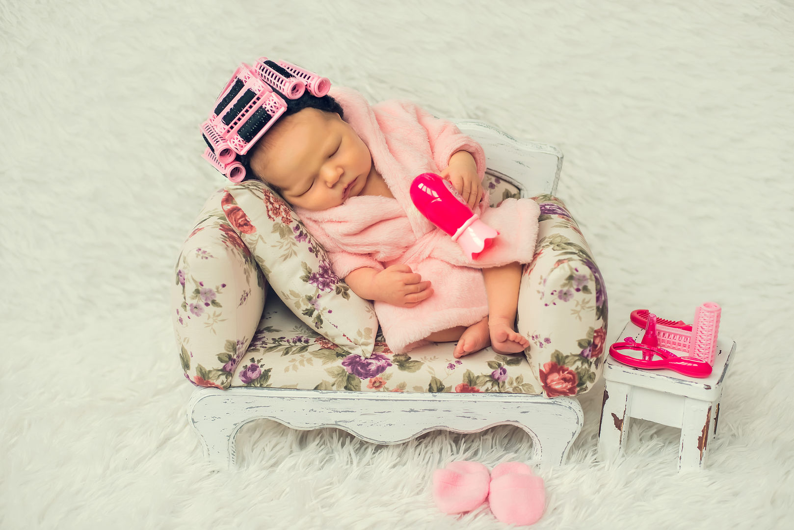 Newborn baby in miniature chair - artistic baby photography