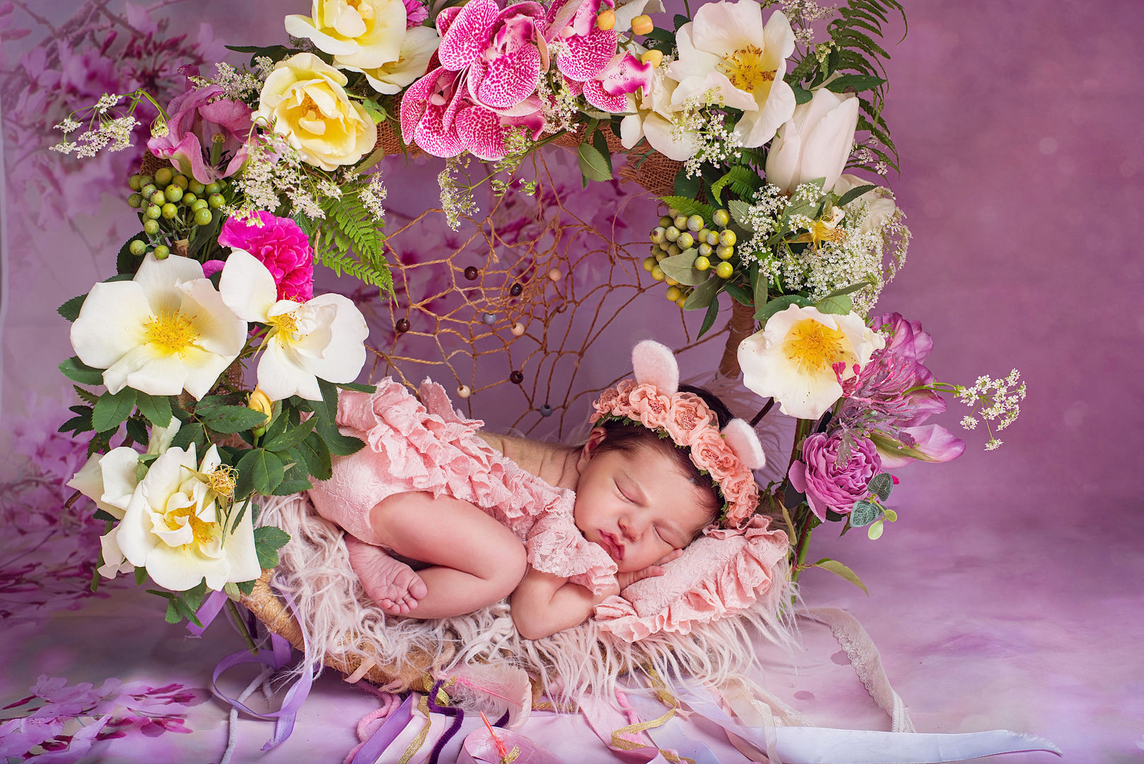 Artistic newborn baby in posed composition - fine art photography