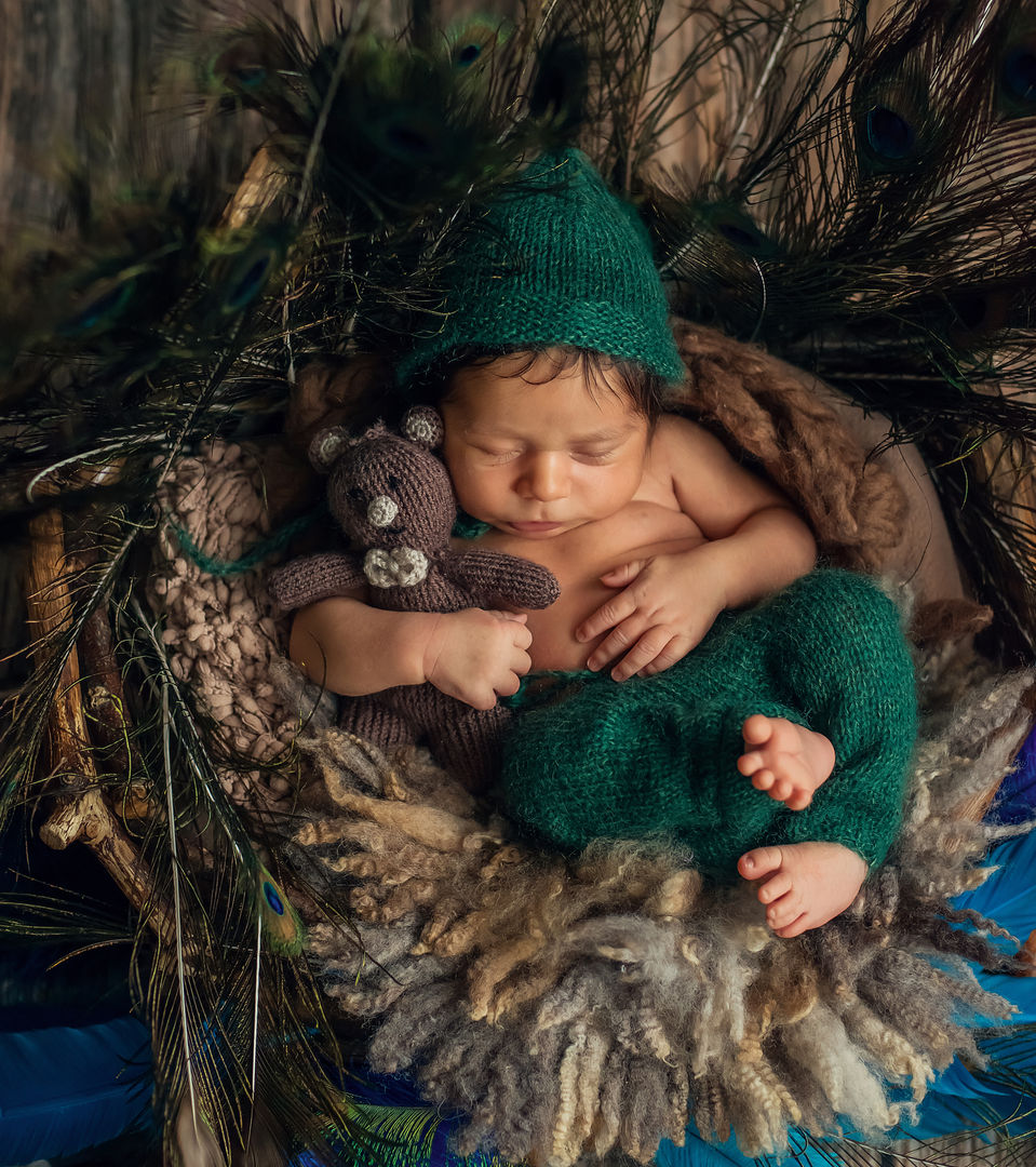 Newborn baby in basket with soft lighting - classic baby photography
