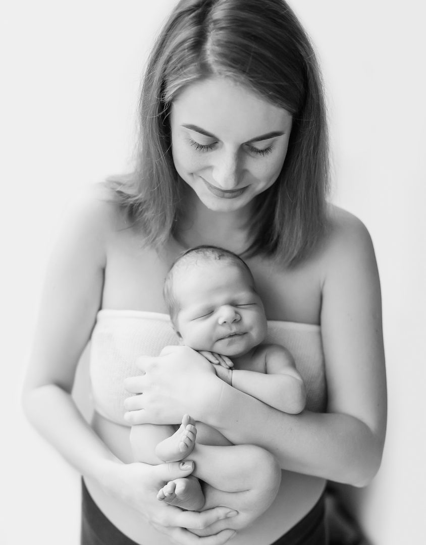 Intimate newborn lifestyle moment in black and white
