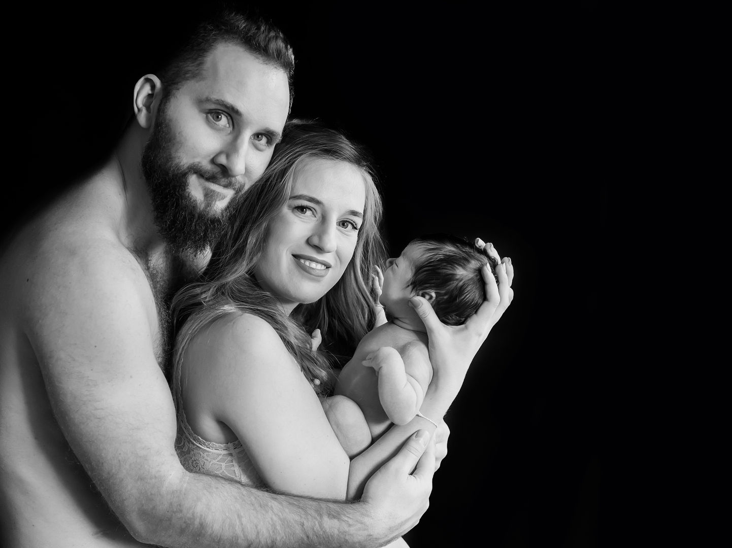 Intimate newborn lifestyle family moment in black and white