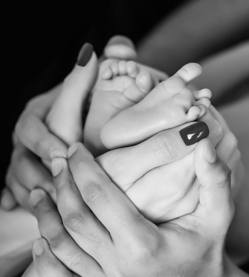 Close-up of baby feet in parent's hands