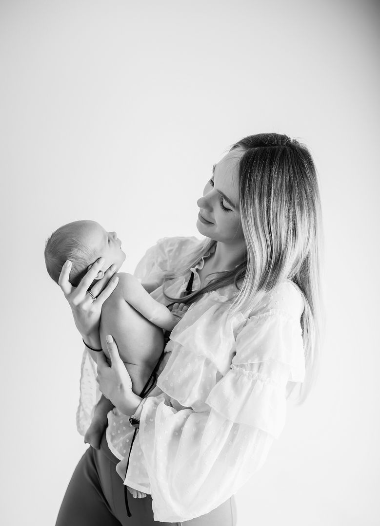 Mother gazing lovingly at newborn baby