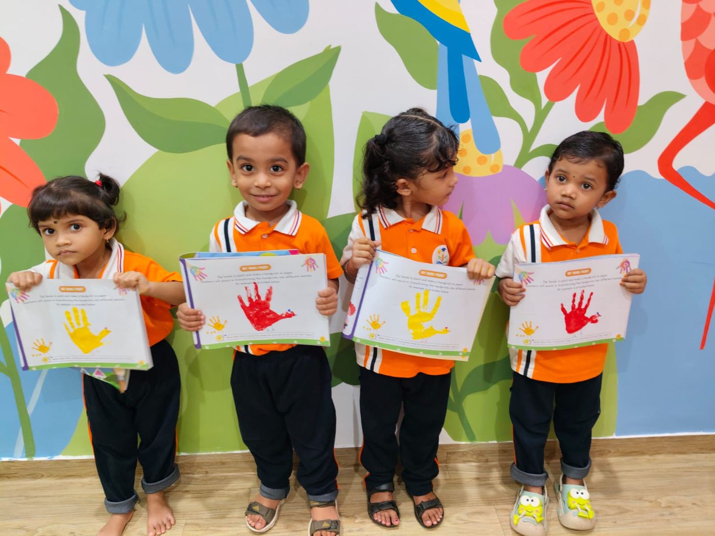 Handprint day — four artists with their certificates.