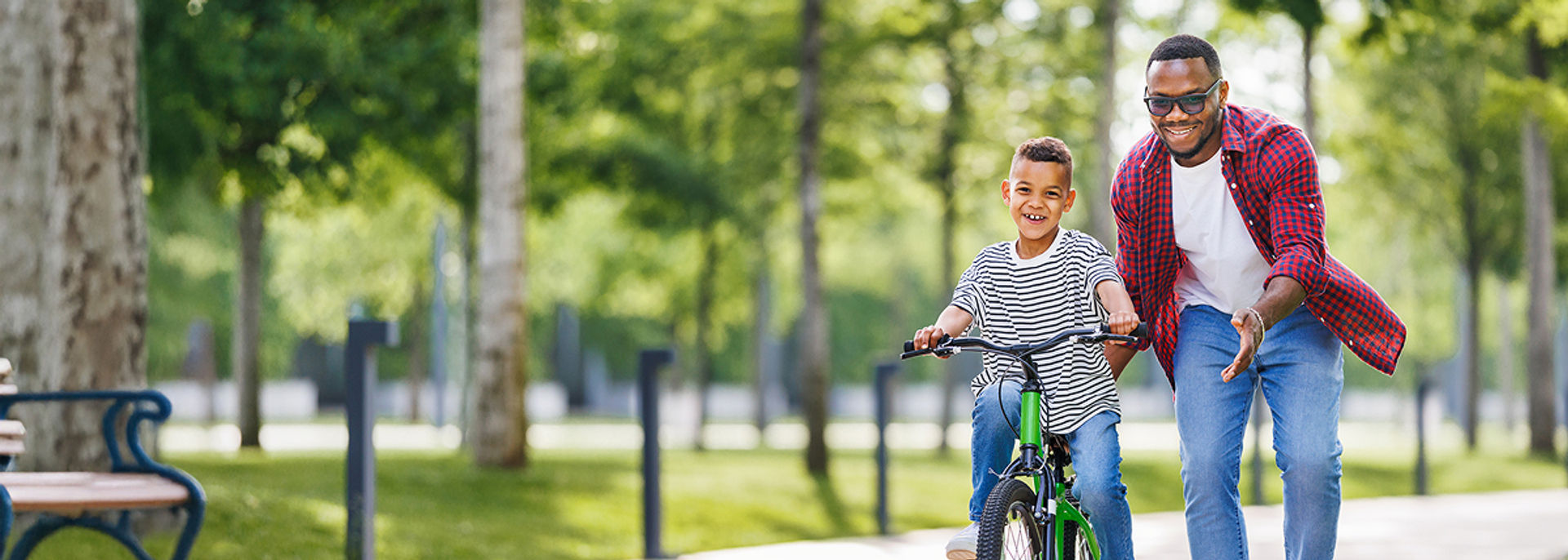 A father teaching his son how to ride a bike