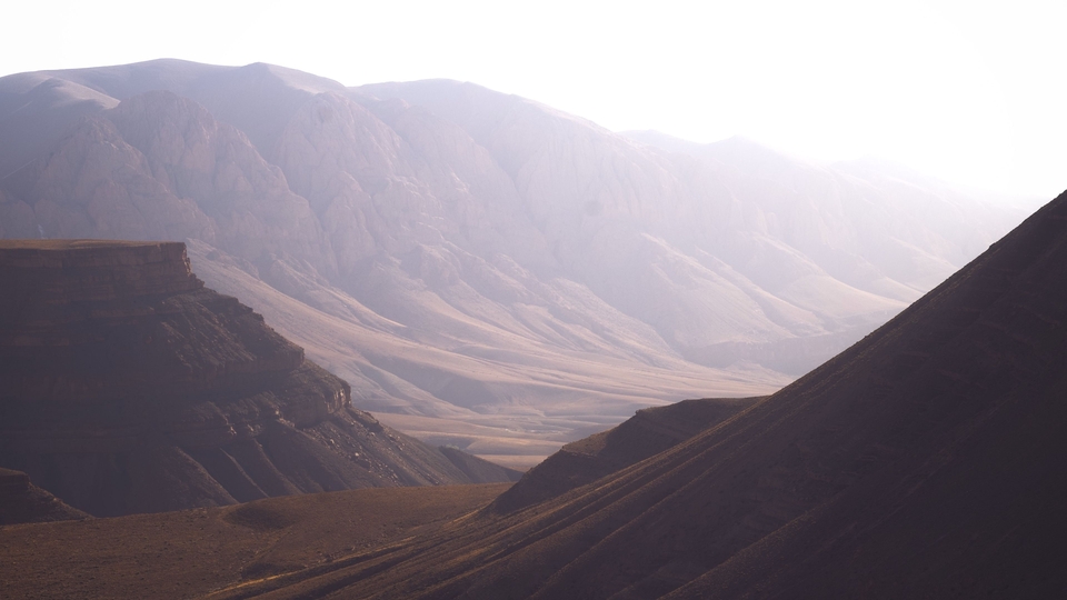 A hazy mountain valley stretches into the distance