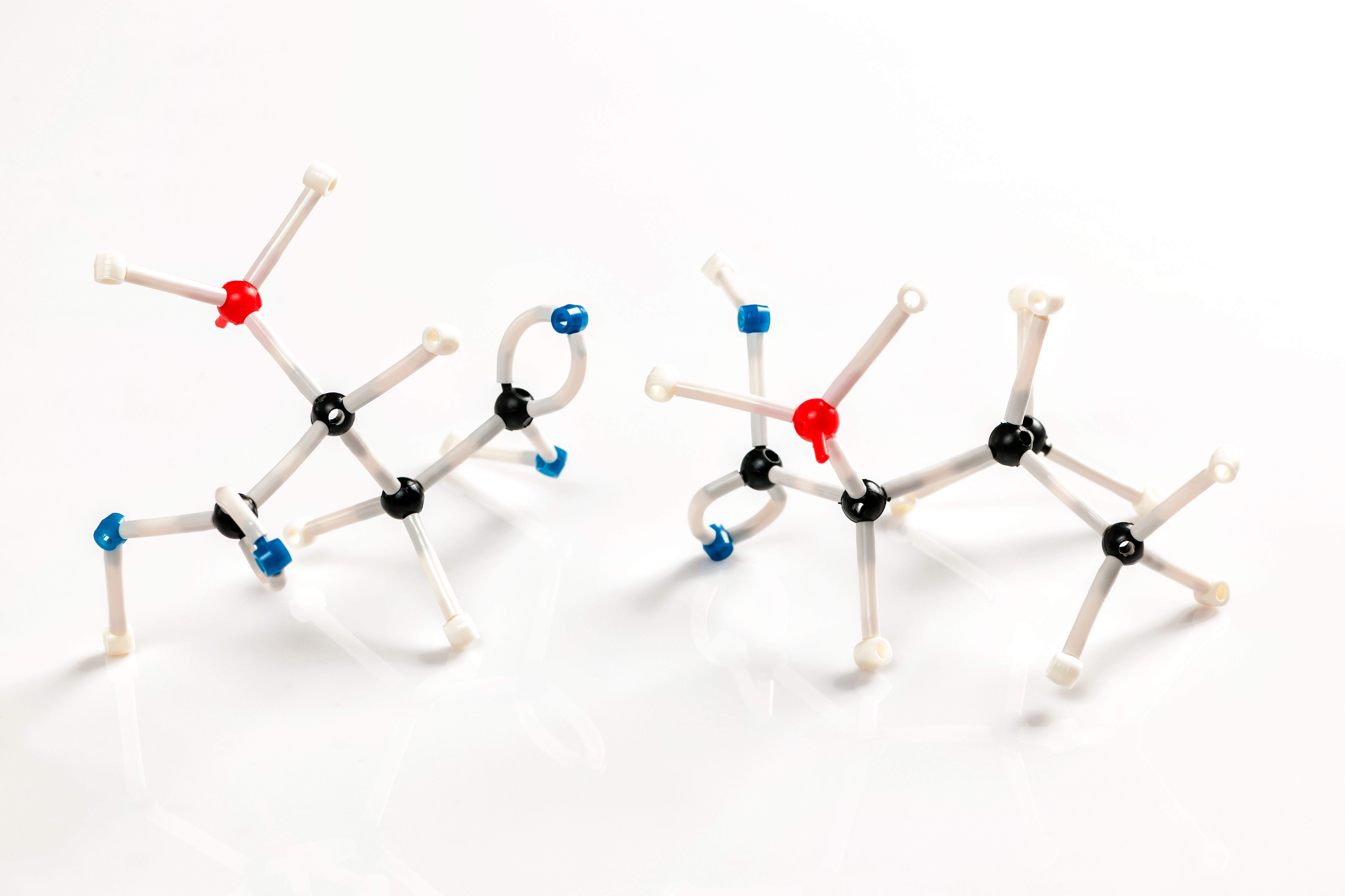 Molecular models of two amino acids representing the building blocks of collagen protein structure — glycine, proline, and lysine are essential for the body's natural collagen synthesis