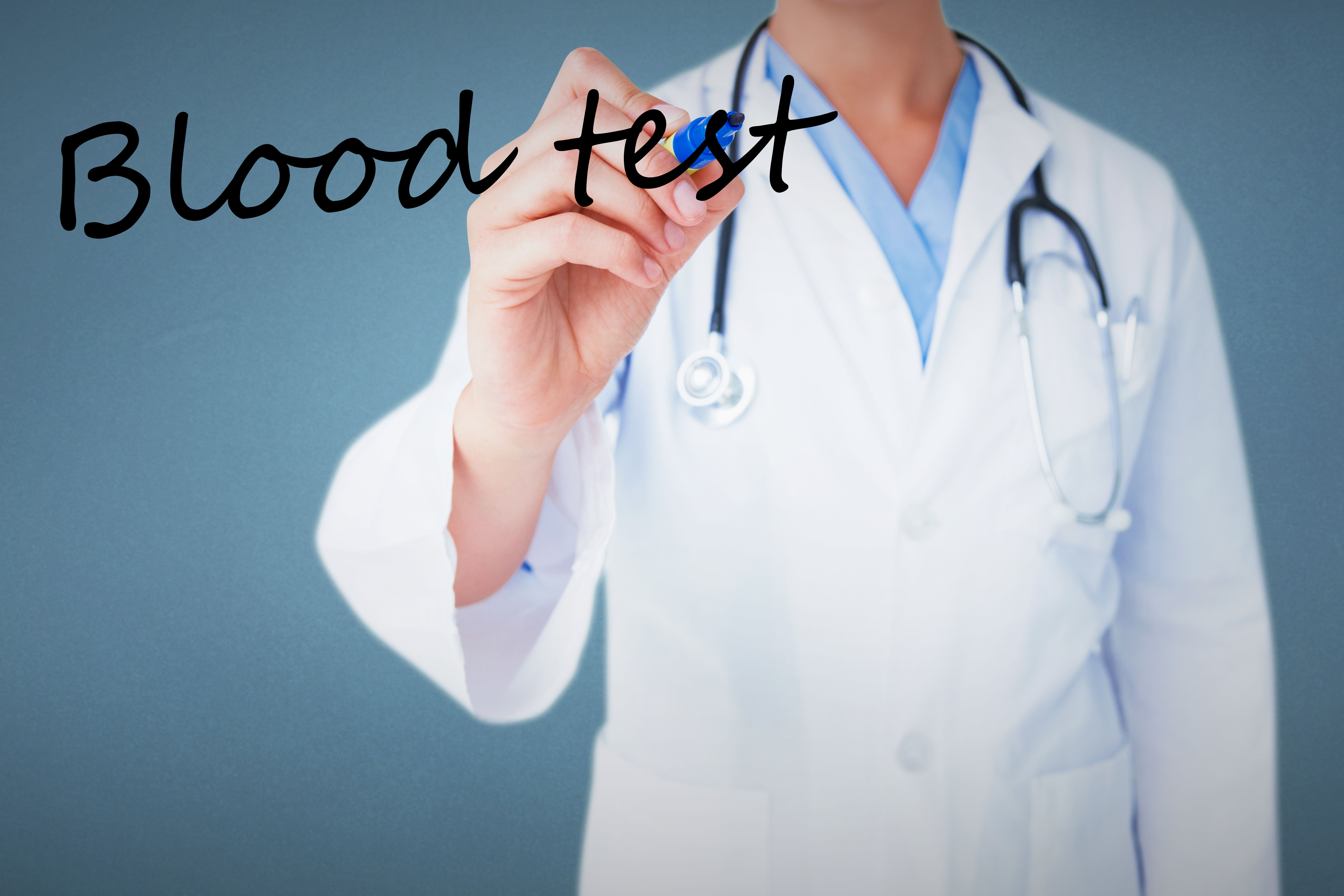 Doctor writing blood test on a glass board against a blue background — targeted blood testing for ferritin, B12, vitamin D, and thyroid function is the most efficient way to identify the actual cause of fatigue