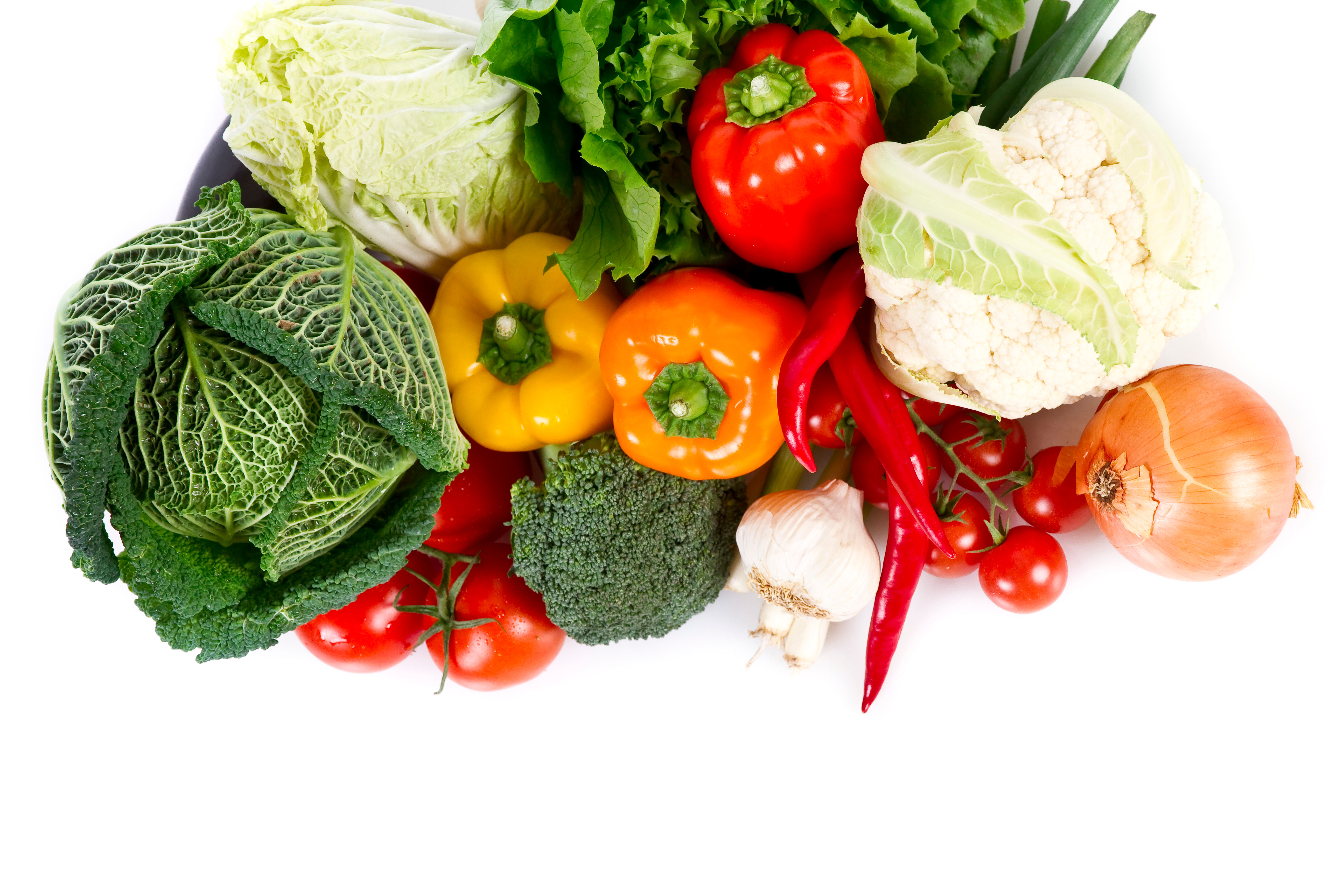 Fresh colorful vegetables including bell peppers, cabbage, tomatoes, and leafy greens — the foundation of good nutrition at every decade of life