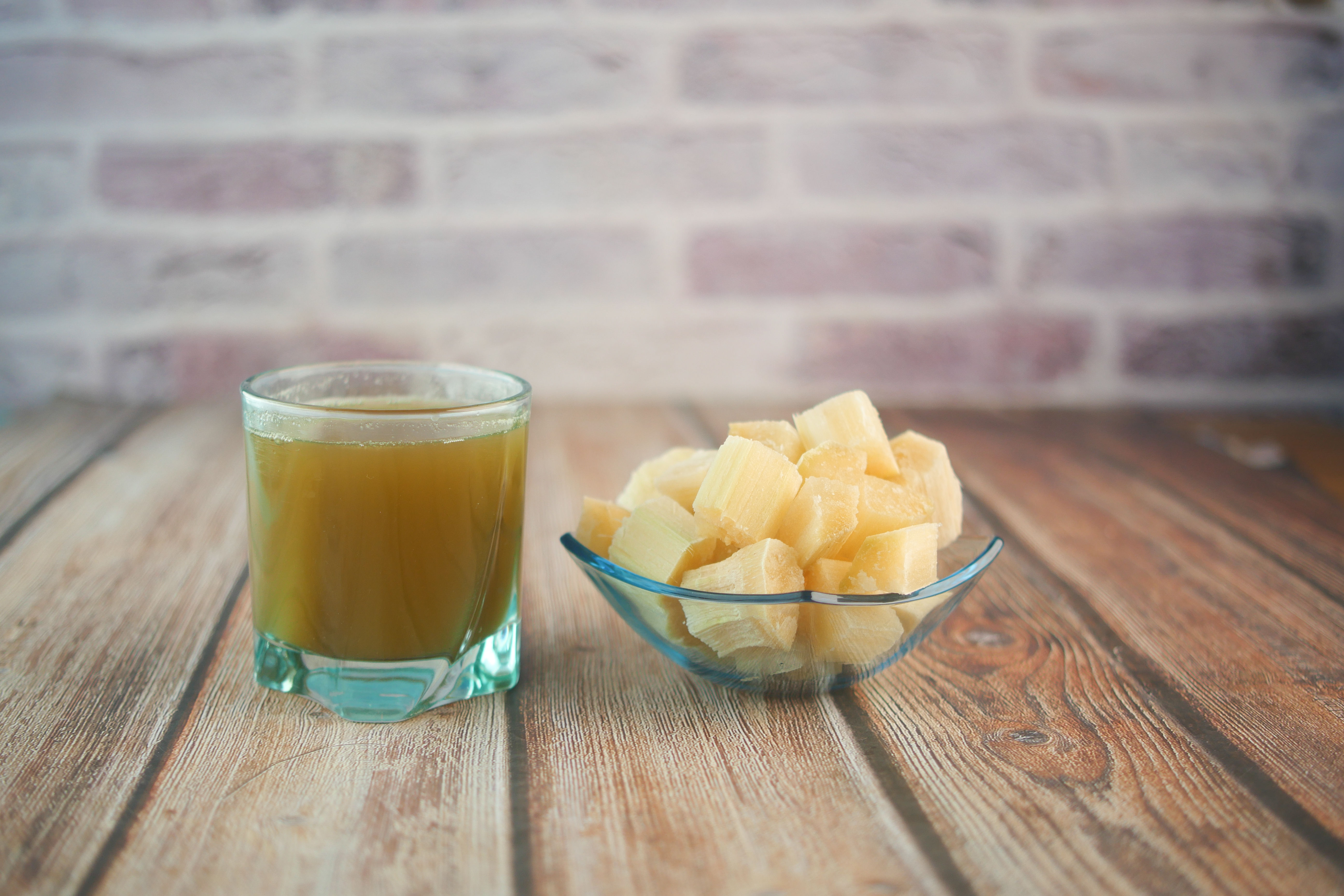 Fresh sugarcane juice on a table — cane sugar and cane syrup are chemically identical to white table sugar despite being marketed as more natural on supplement labels