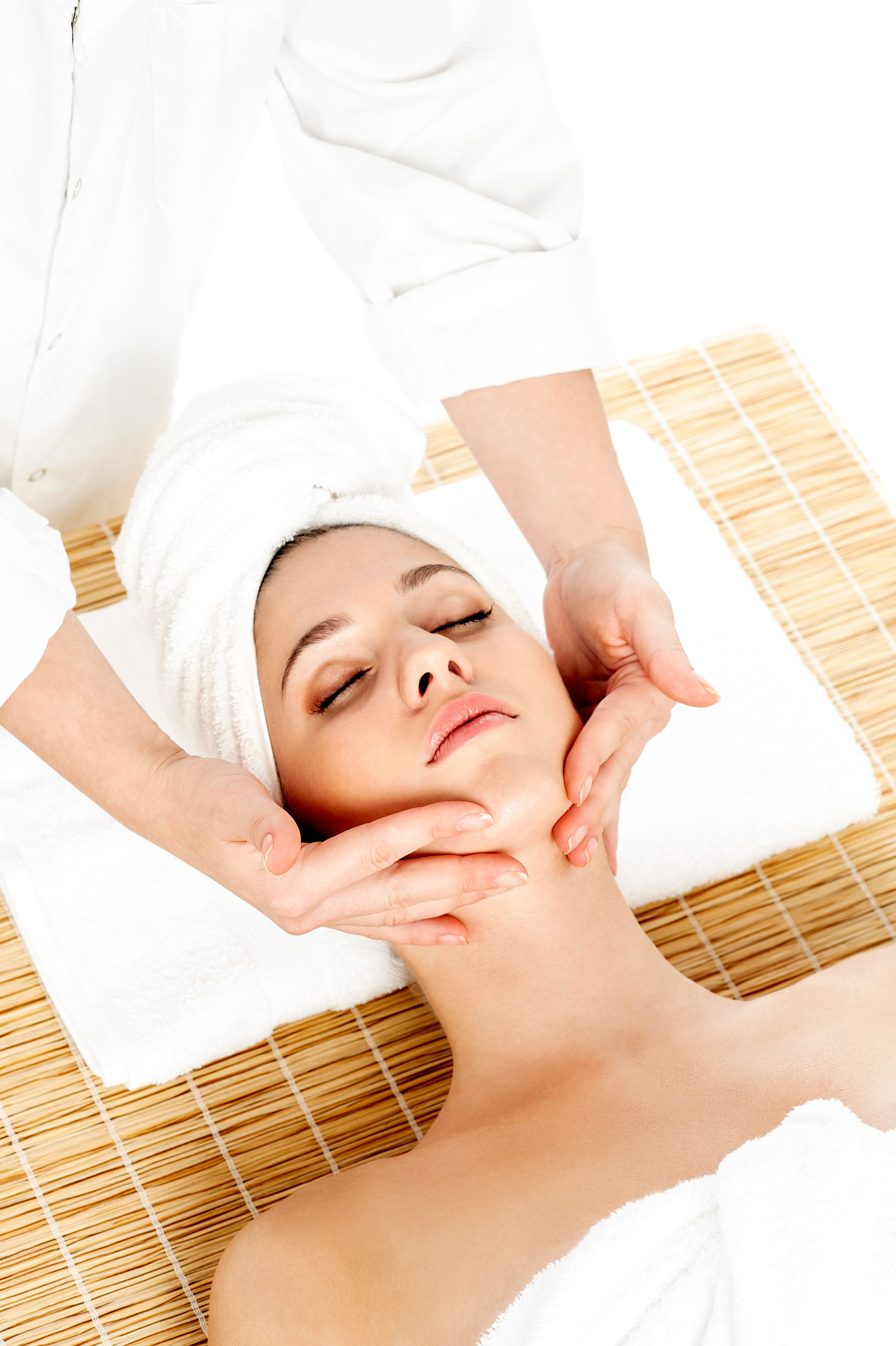 Woman receiving a relaxing spa facial treatment that adds glow to skin — skin, hair, and nails are three distinct tissue types with overlapping but different nutritional needs