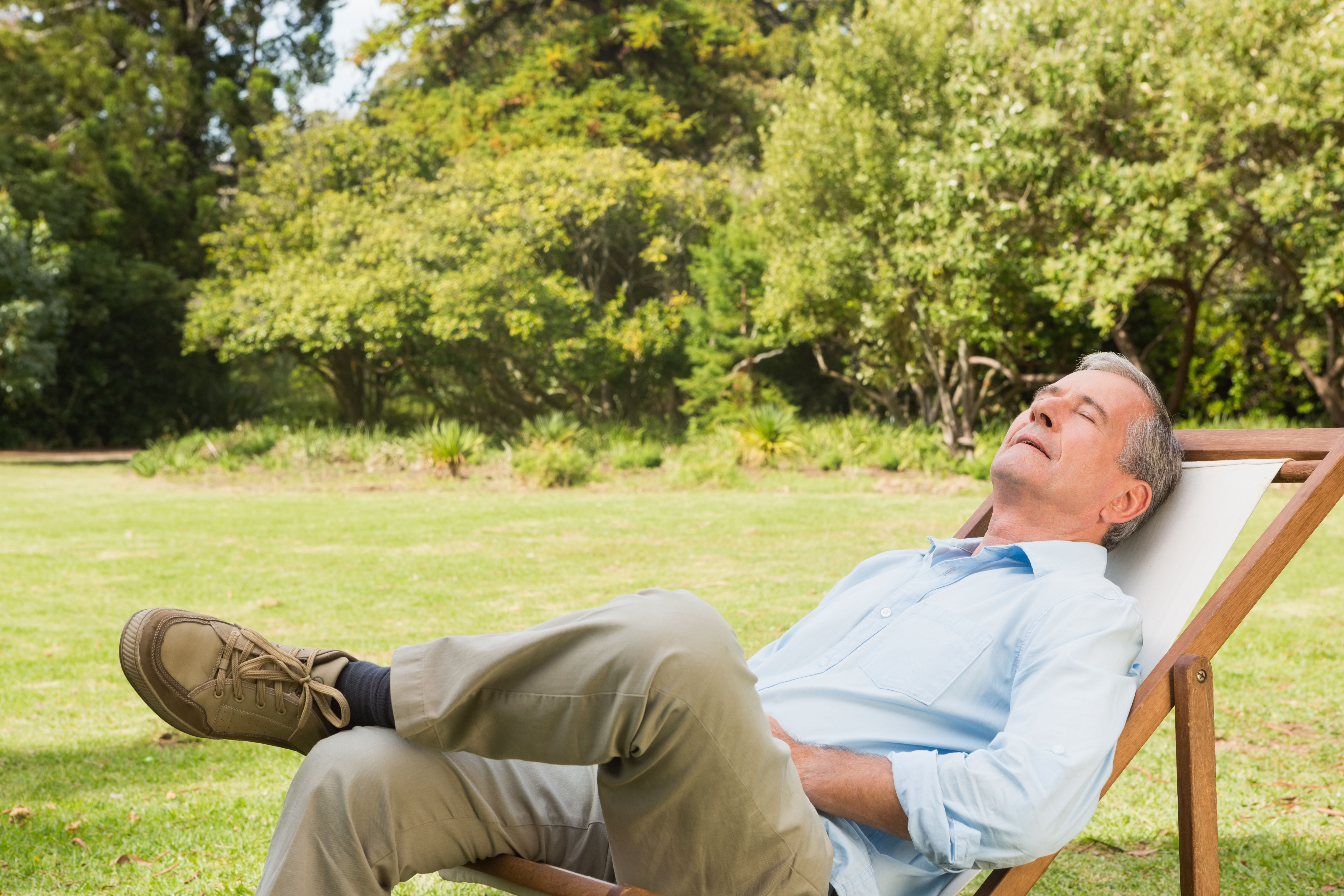 Happy healthy senior man relaxing outdoors representing the ages 60+ density decade — when nutrient density per bite becomes the single most important nutritional principle