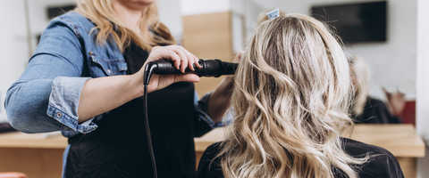 Curling using flat iron in Orlando humidity with a sleek, frizz-controlled finish