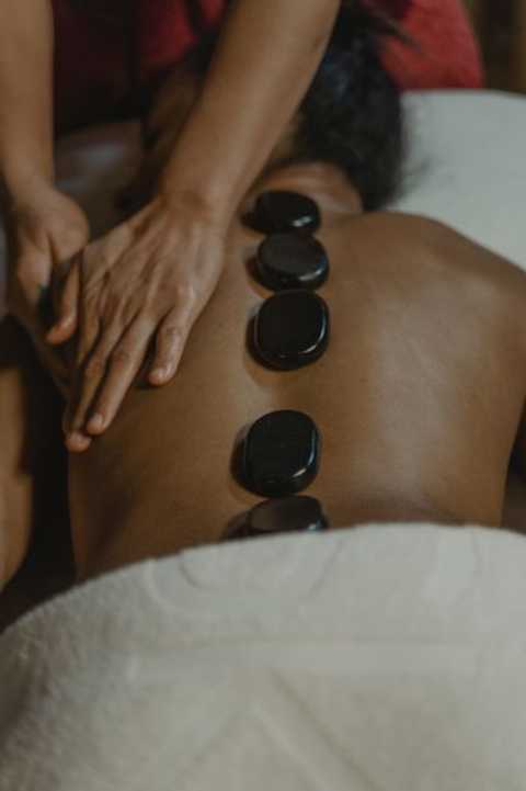 Hot stones massage therapy in Penfield NY using heated stones for therapeutic stone massage