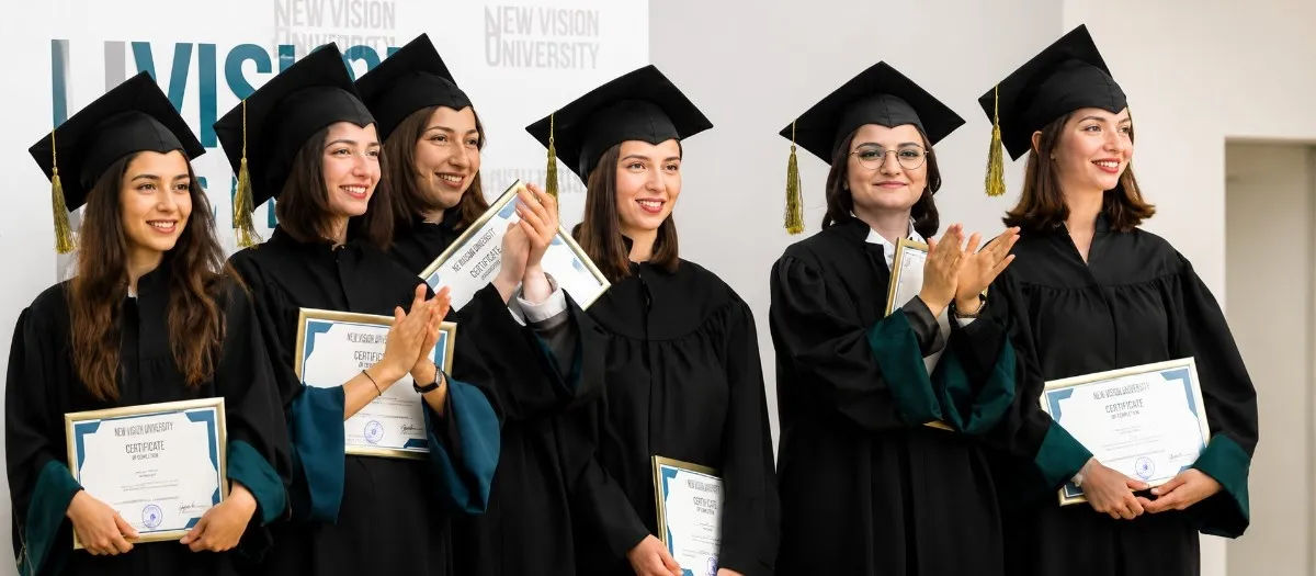 "NVU Certified Graduates Posing at Academic Event"