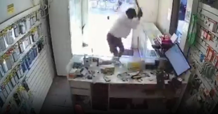 Dissatisfied customer destroys cell phone store with a sledgehammer.