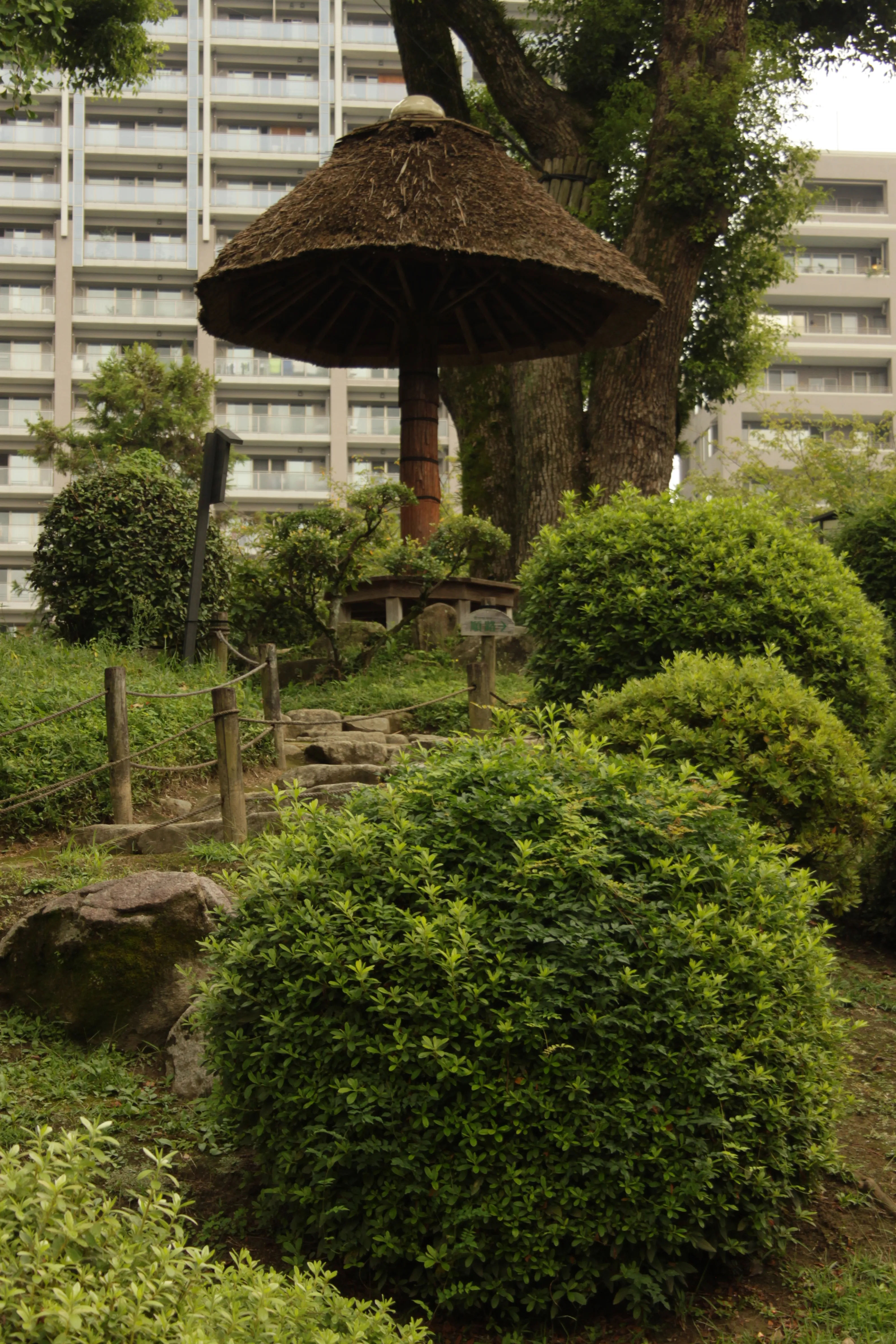 A small garden area within Shukkeien Park, featuring traditional Japanese landscaping.