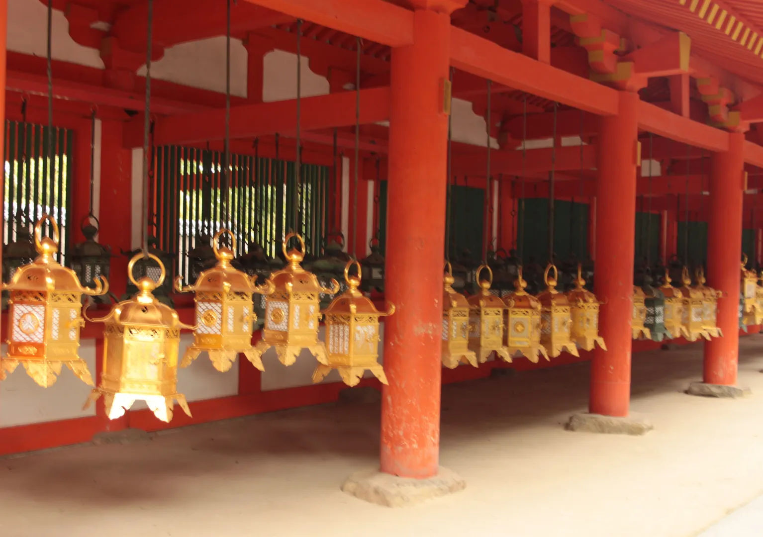 Golden hanging lanterns inside the red-painted halls of Kasuga Taisha, Nara